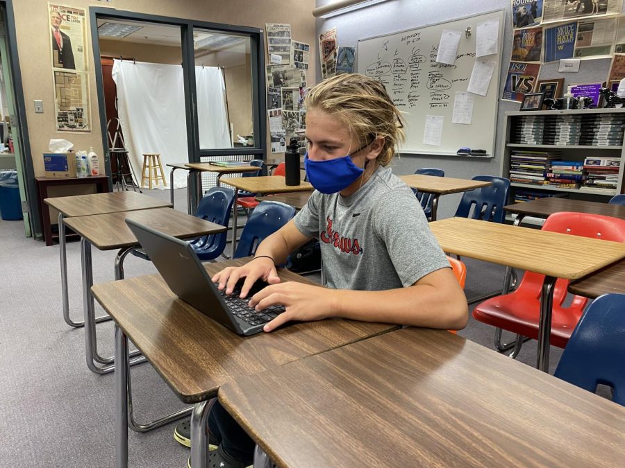 Freshman Eli Thompson works on his computer during class. Students are easily distracted by other applications on their computer, causing them to not learn the required material. 