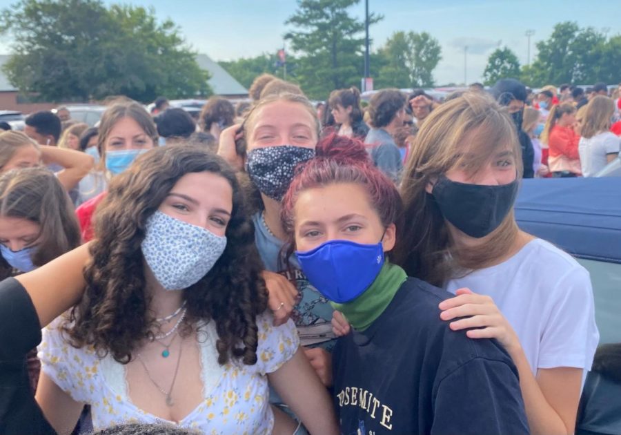 Juniors, Emily Barbus, Emma Vatnsdal, Laura Eaken and Margot Grotland wear masks in a crowded area as they exit the building during a fire drill. Students and faculty are required to wear masks inside the building as of August 16. 