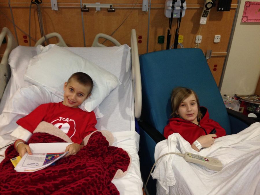 Connor Whaley lays next to his brother, Cobey Whaley, as he receives treatment and his bone marrow transplant.