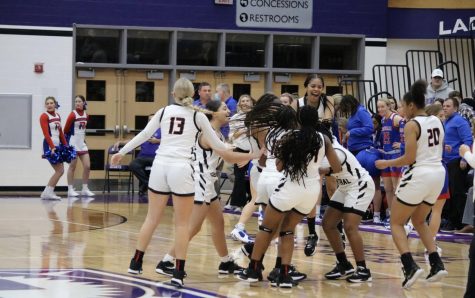 The girls basketball team celebrates after the buzzer goes off and they win the Marion County championship. The girls team has won the tournament two years in a row. 