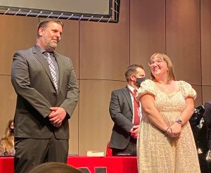 Senior Lucy Neal is recognized with her social studies teacher Jim Tallman at the top 25 ceremony. 