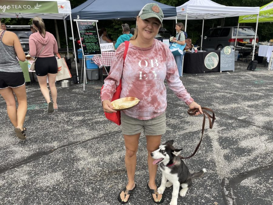 Erica Flores and her dog Jax enjoy a freshly made crepe from Wildschool Market. Jax has enjoyed exploring around the market and meeting the other dogs.