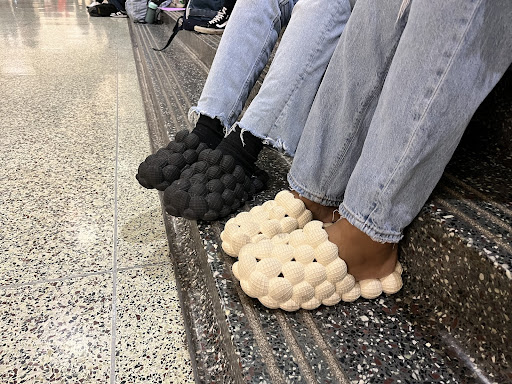 Two students wear the shoes in the Student Center.