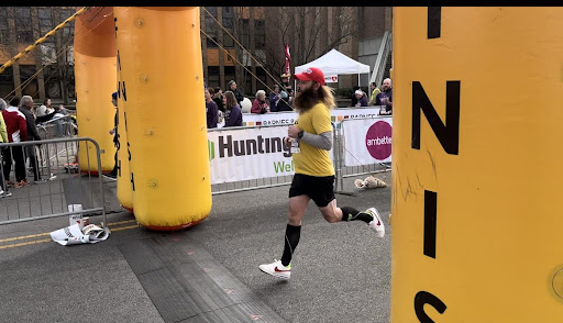 A man dressed as Forrest Gump crosses the Finish Line for the 4.5 mile course. Many people dressed as turkeys and more for the run.