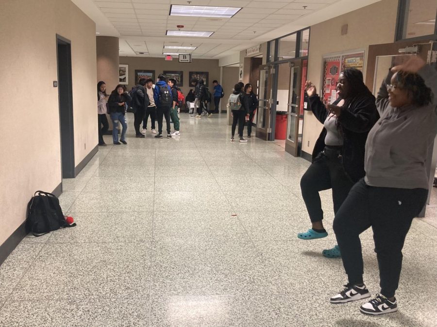 Students film a TikTok outside the cafeteria. 