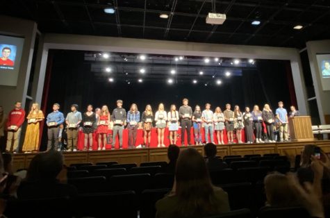 The top 25 students of the class of 2025 stand in front of the audience with their awards. Each student was called up one by one, having their name and yearbook photo displayed on screens to the side of the stage. 