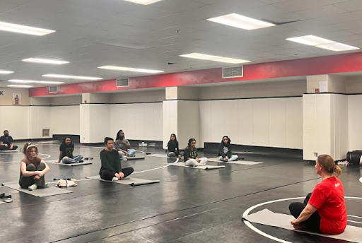 Young women learn yoga to practice self care and appreciate themselves and the legacy that Women’s Month carries.