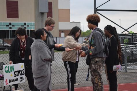 Students receive a glow stick for each lap they complete at Lawrence North’s “Light the Night” event. Beads were also selected by each participant to represent who or what they are walking for.