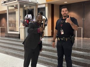 Rent poses with a resource officer in the lower student center before period one on the first day of school. Rent was very active in the hallways on the first day. 