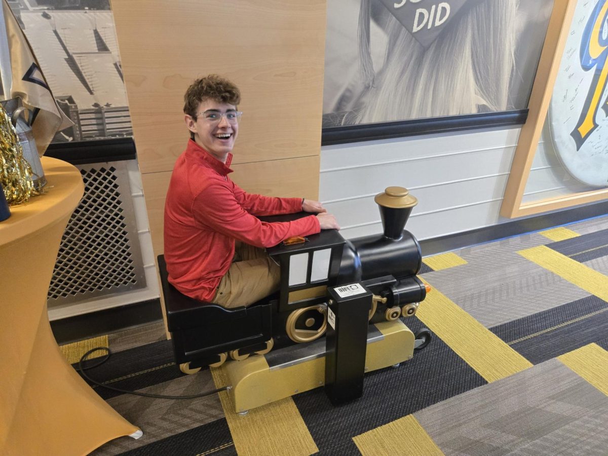 Senior Sammy Bernstein rides the toy train at Purdue University. College visits allow seniors to experience uniqueness of each university.