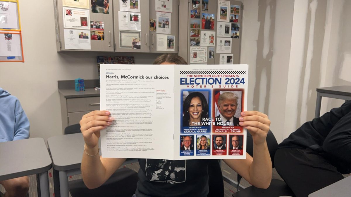 Student reads throught the 2024 Election Voter's Guide. Staying informed is a key part to participating in an election.