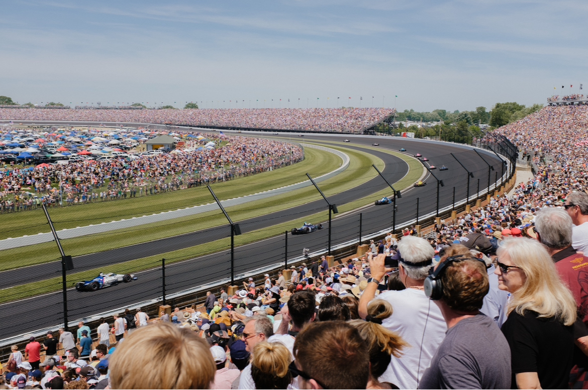 Teams race at the Indianapolis 500. The race is the largest one day sporting event in the world.