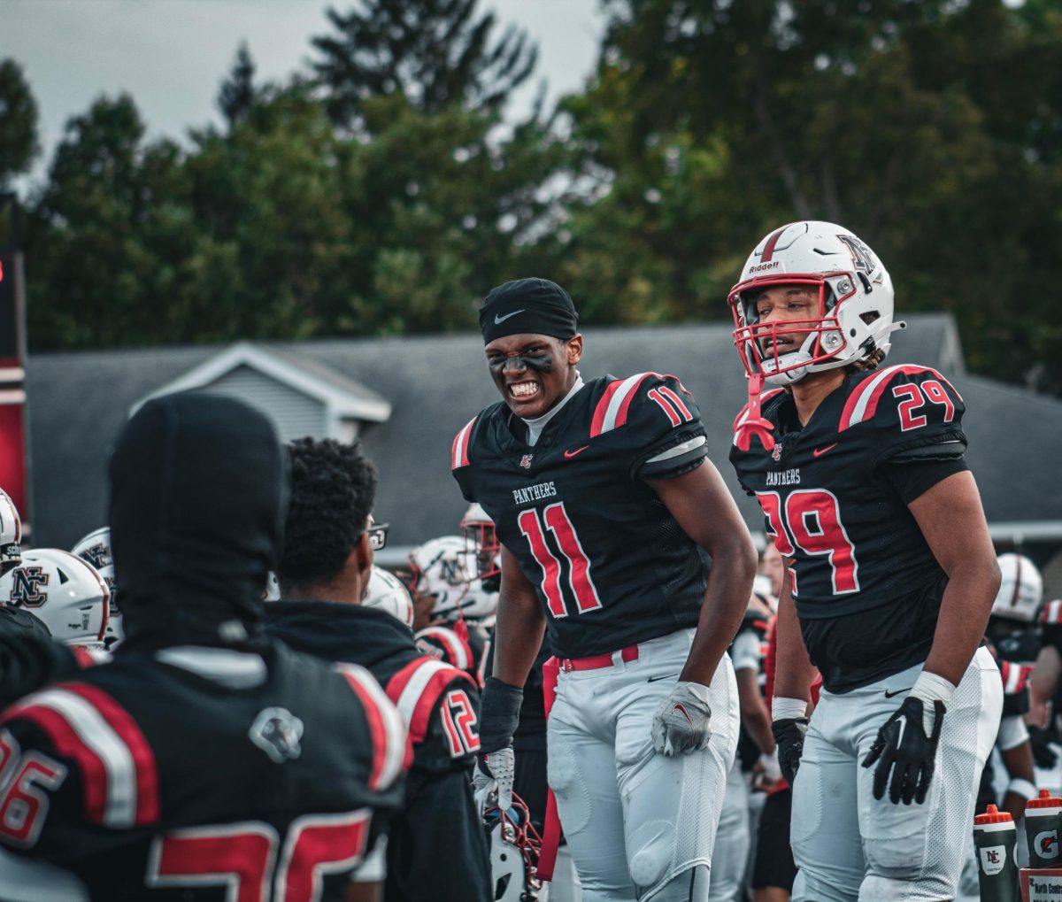 Two football players celebrate a defensive stop. The team finished the season 0-10 