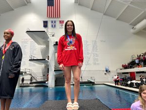 Flessner stands on the podium afer given her first place medal. Flessner won with a score of 441.80.