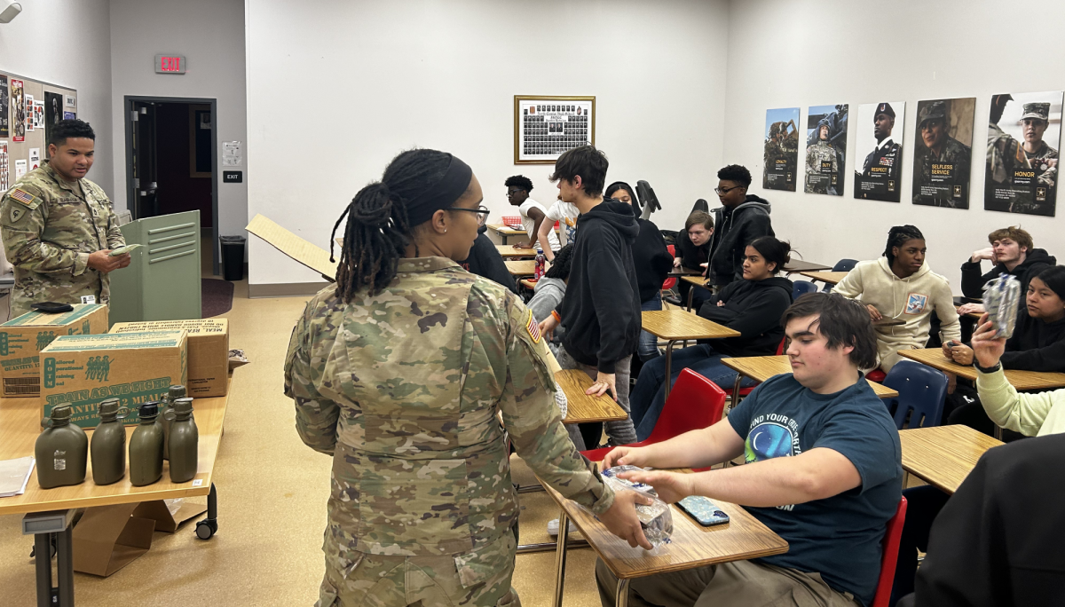 Vilibraxen and Toriss introduce MRE to JROTC students. Each student was able to try a MRE for themselves.