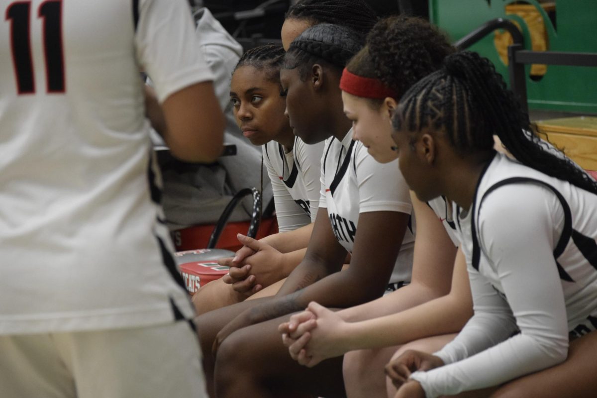 The team listens as Ramey runs through adjustments during a timeout. The coaching staff worked to stay ontop of plays and formation to keep LC at bay.