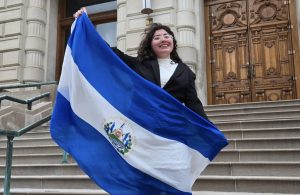 Paraza-Argueta stands in downtown Indianapolis holding the El Salvador flag. Though her mom immigrated from El Salvador before Paraza-Argueta was born, her heritage is importan to her.