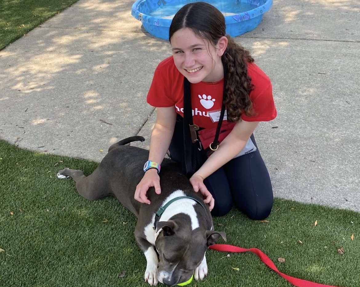 Baker takes care of a dog while volunteering at IndyHumane. She started volunteering in eighth grade.