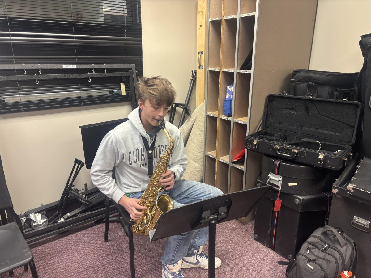 Loomis practices saxophone in one of the rehearsal rooms. He has spent hours working at improving his skills.