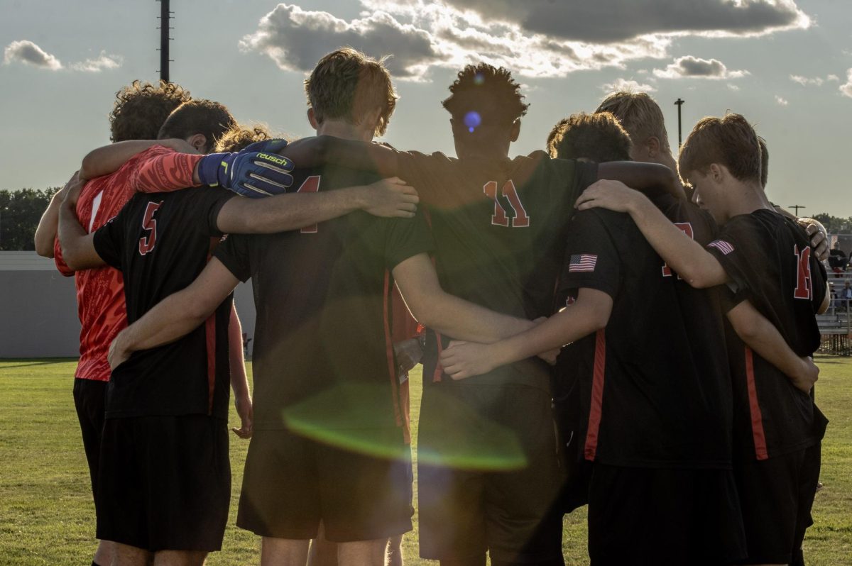 The boys varsity soccer team huddles up before their game against Lawerence North High School. NC won the game in the last minute with the final score 2-1. 