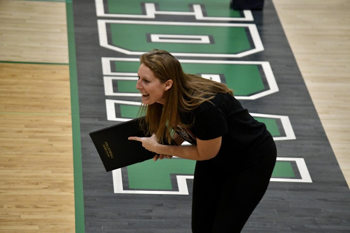 Coach Peresie strategically leads the boys volleyball team during a heated game at Cathedral. This season marks her 11th year as a dedicated coach to her players.