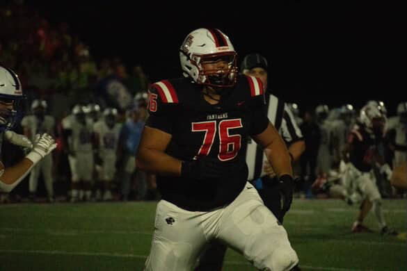 Senior football player Jonatan Bezverhnii runs off the field. Bezverhnii had just made a crucial block to help the offense get down field.
