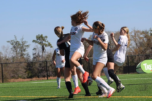 Rebekah TeKrony rush to the ball hoping to lead their team to success. 
