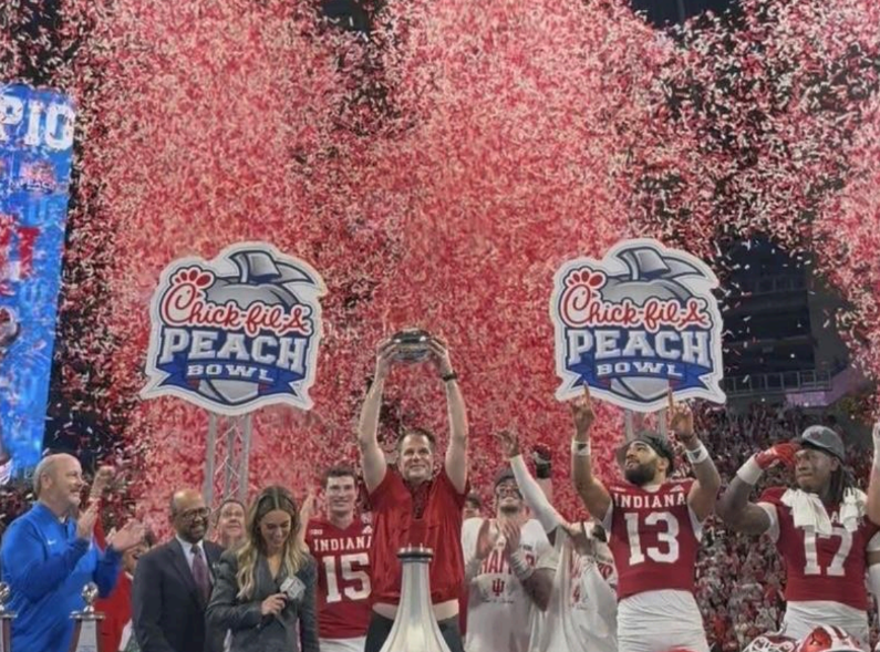 Indiana University Football Head Coach Curt Cignetti hoists Peach Bowl trophy after a 56-22 victory over the Oregon Ducks. With this victory, the Hoosiers advanced to the National Championship for the first time in program history. 
