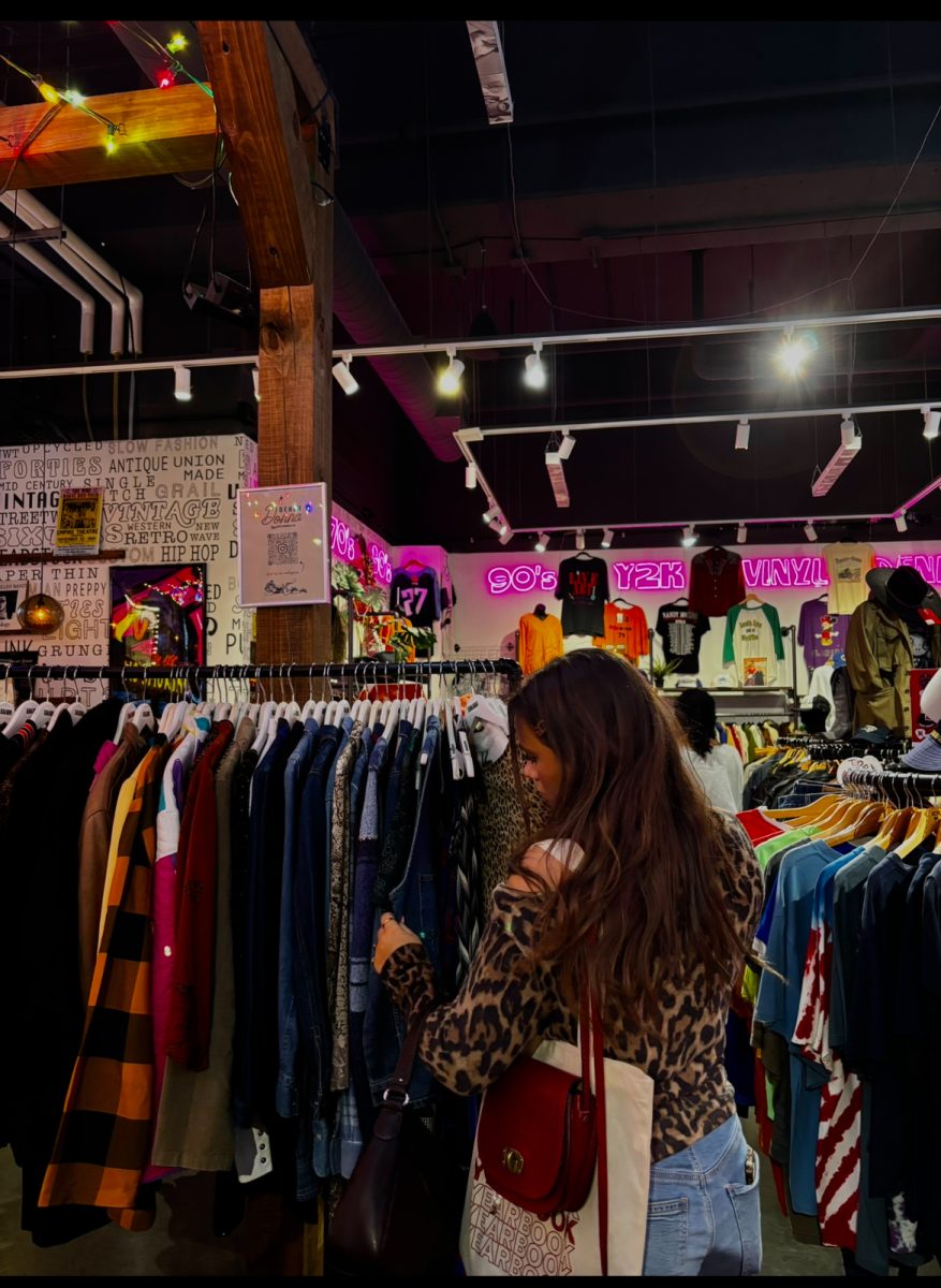Senior Dominica Dandelet Vento shops for clothes at a thift store in Nashville. There has been a rise in popularity of vintage stores and recycled clothing.