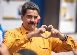 Venezuelan President, Nicolás Maduro, holding up heart hands to a crowd. He was recently captured in “Operation Absolute Resolve”. Photo by Creative Commons.