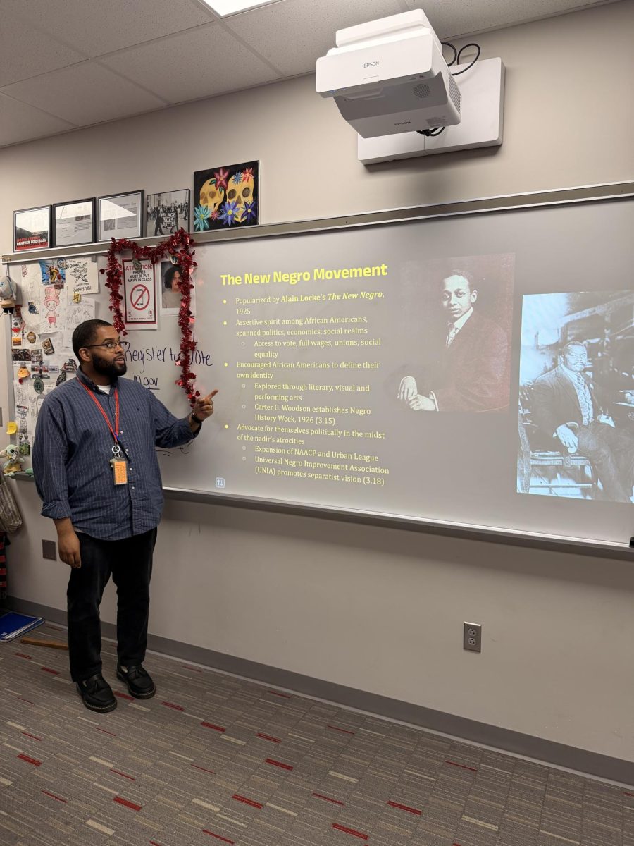 Course instructor, Darrien Grays going over a lesson for the AP African American Studies class while it's in session. “We begin the class by talking about ancient Africa. I think that is an experience that most students in high school are just schools in general don't get.” AP African American studies teacher, Darrien Grays said.