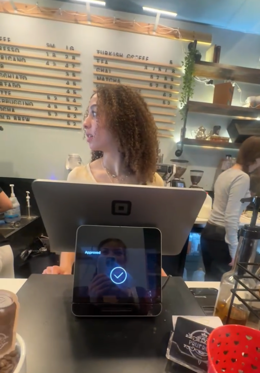Junior Ruby Brown works the cash register at her job after school and track practice. "School and practice can be tiring, but working with my friends can be fun most days,"  Brown said. 
