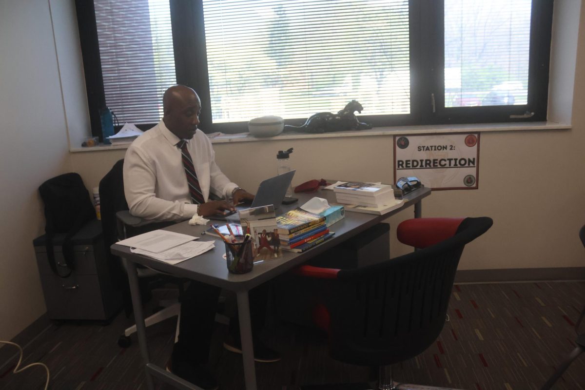 Sherman Flucas II sits at his desk in the Success Center. Flucas’ job is to work with students to reconcile their actions and get them ready to enter back into the learning environment. “I tell students my story –  where I am, where I was, what I have been through, to get them to truly understand that the words and the interpretation that I'm providing isn't coming from a book, but from a more mature, experienced standpoint,” Flucas said. “When I tell them it kind of resonates with them that everything they need is already inside of them they just gotta have the courage to do it.”
