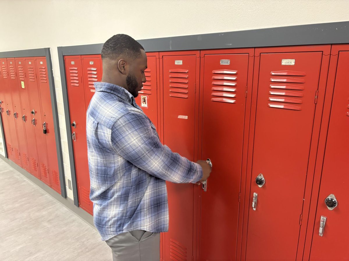 Special needs teacher JaQuan Buchanan opens up locker. North Central has many lockers throughout the school but many of them go unused. 