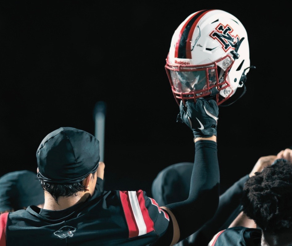 North Central football team huddles up following first win in three years. The team beat Brebeuf Jesuit Preparatory School 35-13.